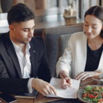 two people talking and pointing at a paper