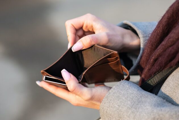 holding an empty wallet