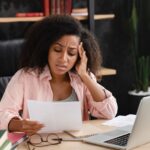 Woman reading mortgage documents