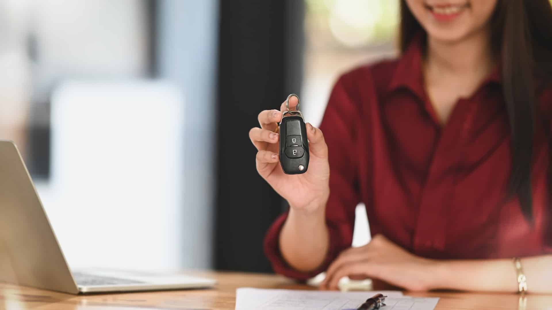 woman holding car key